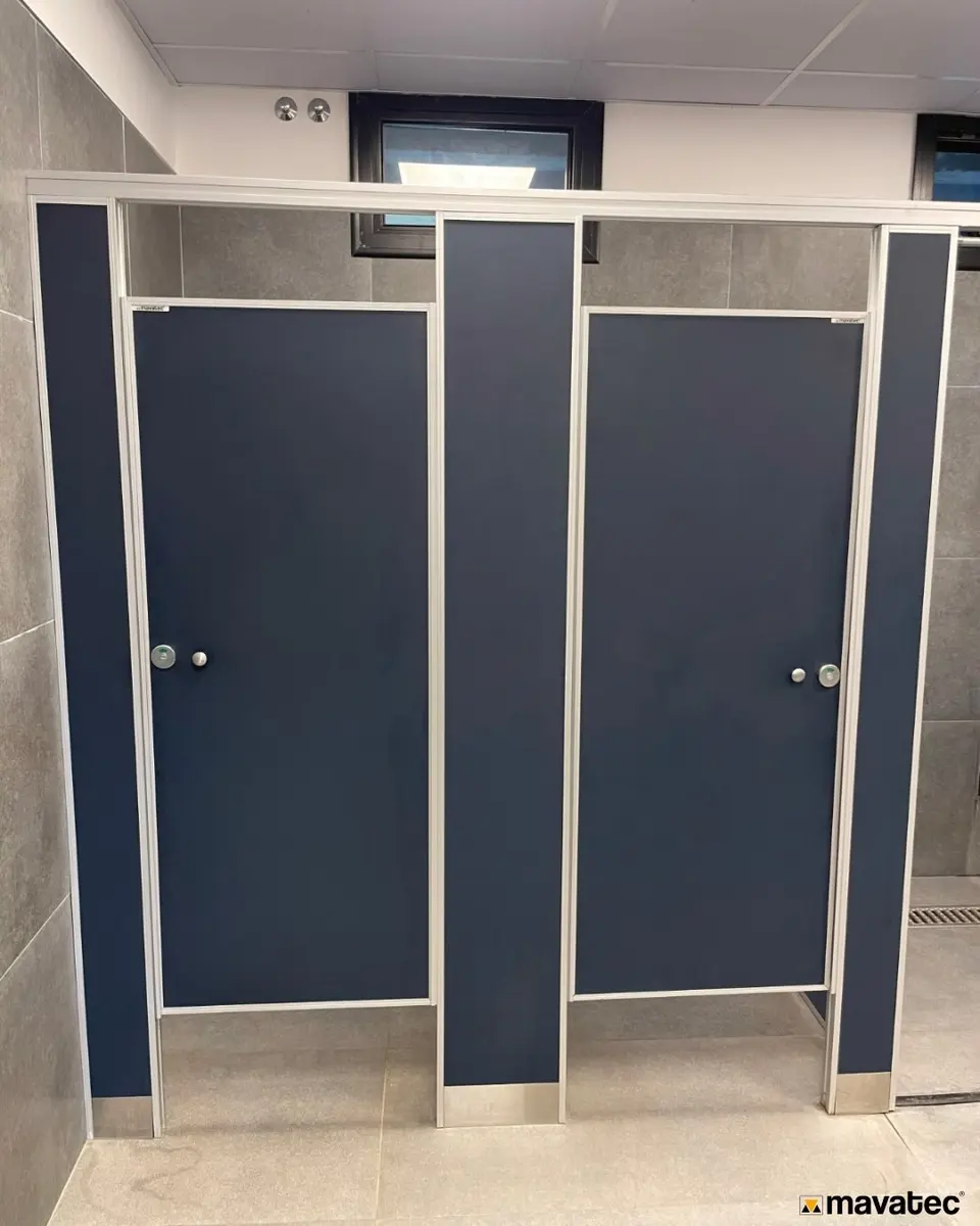 Baños del club Regatas Bella Vista con tabiques sanitarios azules (foto 2 de 6)